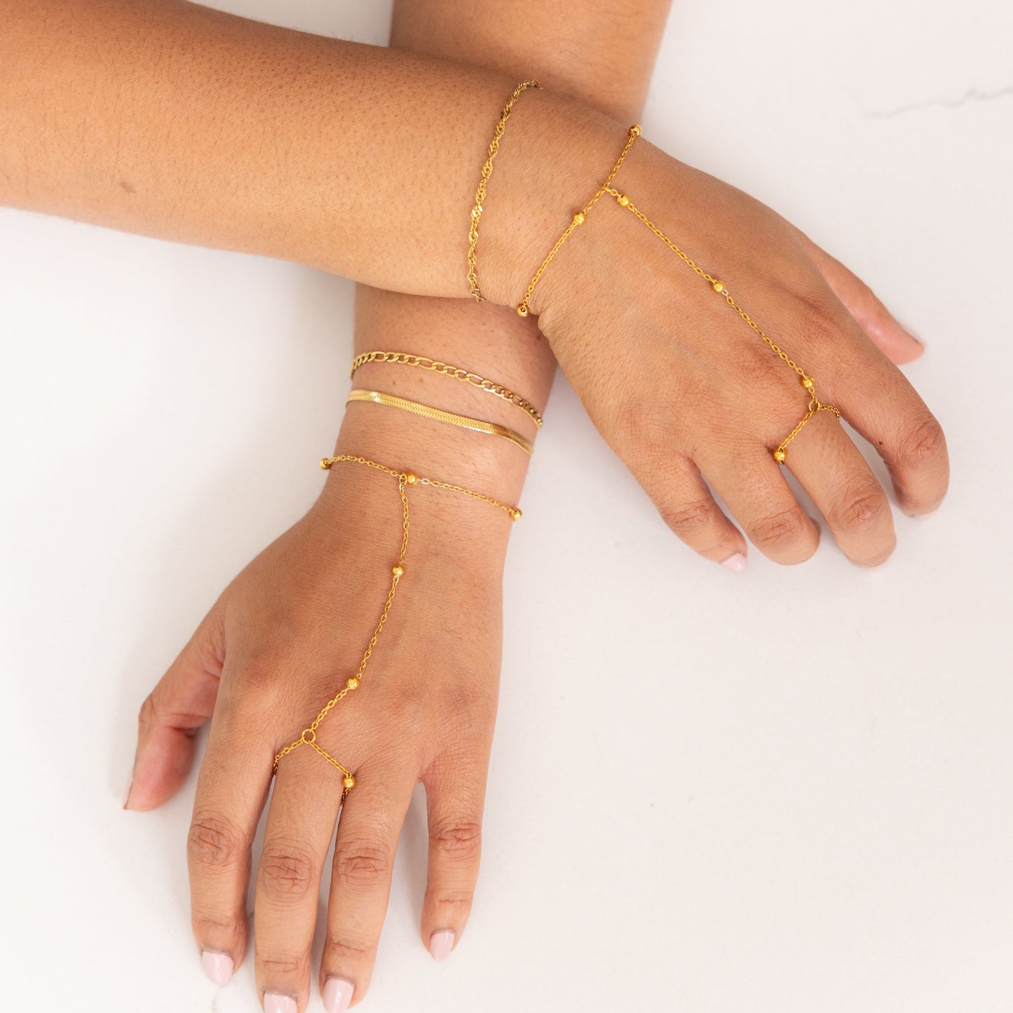 Gold hand chain on a white background